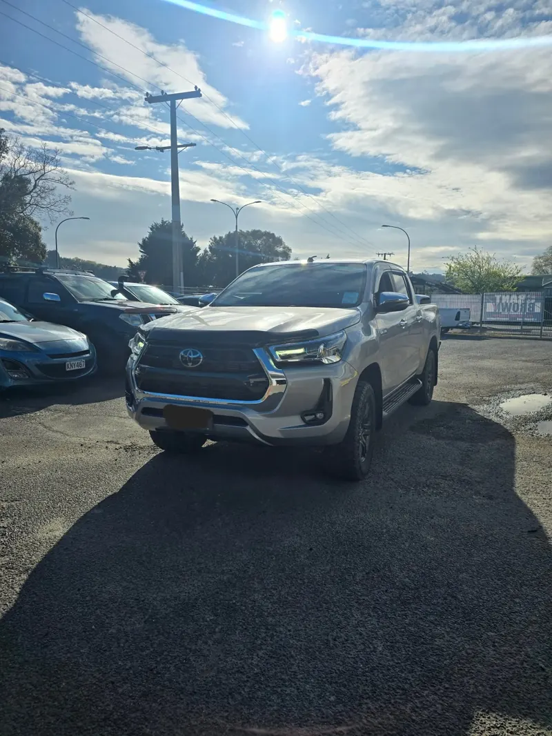 Silver Toyota Hilux in the One Stop yard in the sun